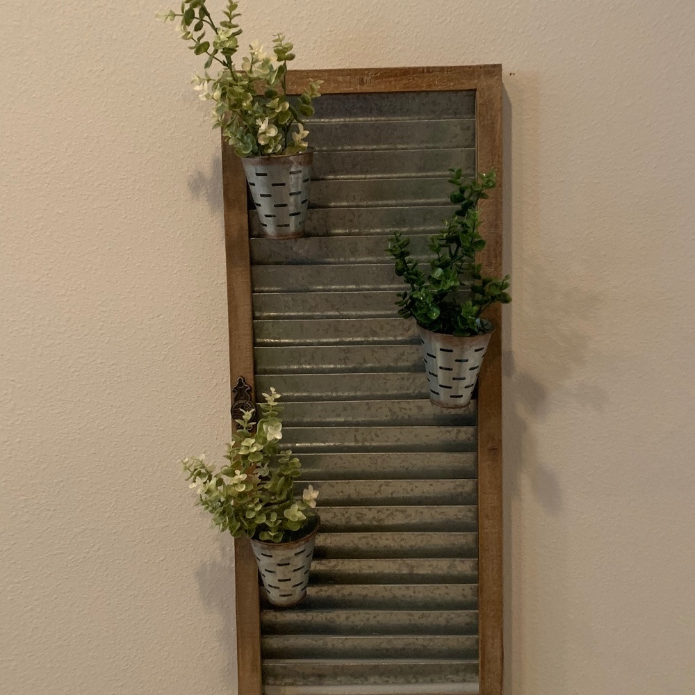 Metal wall decor with greenery